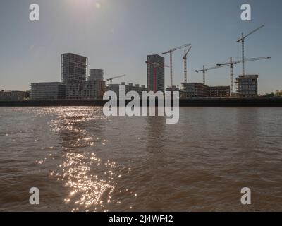 Antwerpen, Belgien, 17. April 2020, Baustelle von Wohnungen mit Kranen auf der Schelde in Antwerpen, aufgenommen von einem vorbeifahrenden Boot im EA Stockfoto