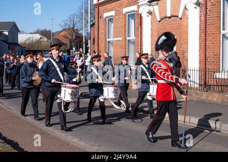 Der Mann in Militäruniform führt die Flötenkapelle und Mitglieder des Orangenen Ordens durch Ballymena während der jährlichen Parade zum St. Patrick's Day im Jahr 2022. Stockfoto