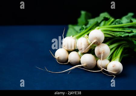 Weiße Radieschen auf einer dunklen Oberfläche Stockfoto