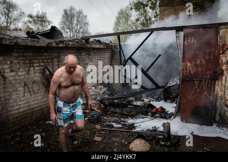 Charkiw, Ukraine. 18. April 2022. Ein Garagenbesitzer untersucht seine zerstörte Garage, nachdem die Feuerwehrleute nach einem russischen Raketenangriff auf die Stadt das Feuer in Charkiw gelöscht hatten. Nach der russischen Konzentrationsoffensive im Osten der Ukraine ist Charkow, die zweitgrößte Stadt der Ukraine, nun ständig von russischen Bombardierungen und Luftangriffen bedroht. Kredit: SOPA Images Limited/Alamy Live Nachrichten Stockfoto