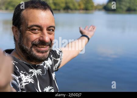 Aktiver, hübscher, reifer Kaukasischer Mann, der Selfie auf einem See zeigt. Outdoor-Adventure-Konzept. Stockfoto