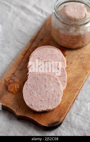 Hausgemachter Jagdwurst auf rustikalem Holzbrett, Seitenansicht. Stockfoto