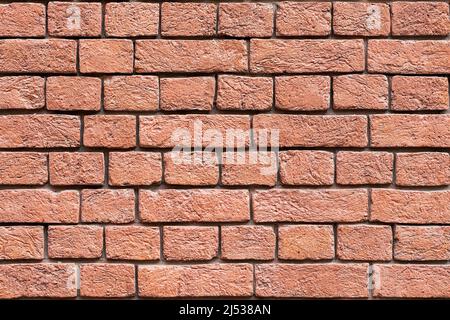 Alte Backsteinmauer in roter Farbe in Nahaufnahme. Hintergrund Stockfoto