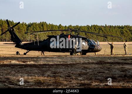 Soldaten, die dem General Support Aviation Bataillon, 12. Combat Aviation Brigade, zugewiesen wurden, sichern ihre Flugzeuge am Ende der medizinischen Evakuierungsübung während ihrer Qualifikation als Luftwaffe im Rahmen einer einwöchigen Trainingsübung im Trainingsgebiet Nadarzyce, Polen, 1 25. März 214. 2022. Das Training ermöglicht es den Flugbesatzungen, ihre Kenntnisse mit dem M240H-Maschinengewehr-Waffensystem zu verbessern und ihre Bereitschaft zu verbessern, Evakuierungsmaßnahmen für Opfer zu unterstützen. Die CAB von 12. ist unter anderem dem V Corps, dem amerikanischen Forward Deployed Corps in Europa, zugewiesen, das ebenfalls arbeitet Stockfoto