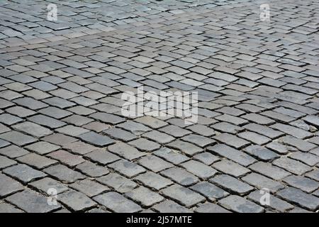 Abstrakter Hintergrund der alten grauen gepflasterten Straße in der alten europäischen Stadt. Stockfoto