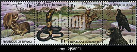 Eine in der Republik Burundi gedruckte Briefmarke zeigt eine Gruppe von Tieren unter den Steinen in Zentralafrika, 1978 Stockfoto