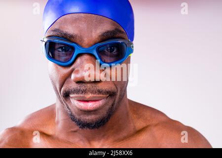 afro latin Mixed Race Mann Schwimmer immer bereit, schwimmen isoliert auf weißem Hintergrund im Studio Stockfoto