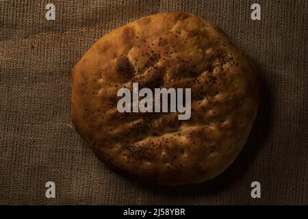 Draufsicht auf ein Ramadan-Pita-Brot auf Jute-Hintergrund. Stockfoto