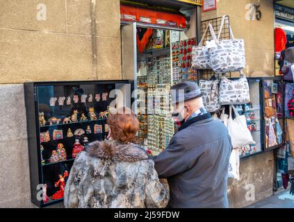 Mann und Frau, ein älteres Paar, das souvnir-Artikel im Souvenirladen in Madrid, Spanien, ansieht Stockfoto