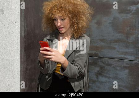 Portrait junge lateinische Frau mit Mobiltelefon mit überraschende Ausdruck Stockfoto