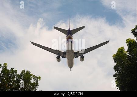 04. November 2021, Singapur, Republik Singapur, Asien - Ein Passagierflugzeug der Thai Airways Boeing 777-200 mit Registrierung HS-TJV auf dem Weg zum Changi International Airport. Thai Airways ist Mitglied der Luftfahrtallianz Star Alliance. [Automatisierte Übersetzung] Stockfoto