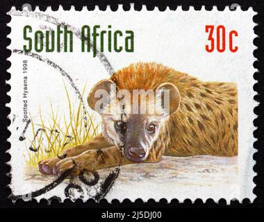 SÜDAFRIKA - UM 1998: Eine in Südafrika gedruckte Briefmarke zeigt Spotted Hyena, Crocuta Crocuta, Animal, um 1998 Stockfoto