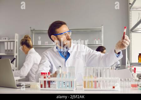 Arzt Wissenschaftler in Laborstudien Bluttest auf das Vorhandensein von gefährlichen Krankheiten. Stockfoto