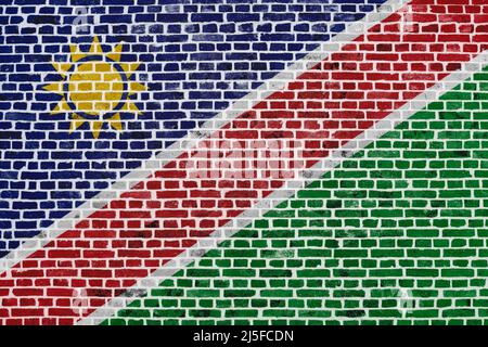 Nahaufnahme einer Ziegelmauer mit der Flagge Namibias. Stockfoto