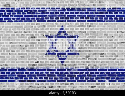 Nahaufnahme einer Ziegelmauer mit der Flagge Israels. Stockfoto