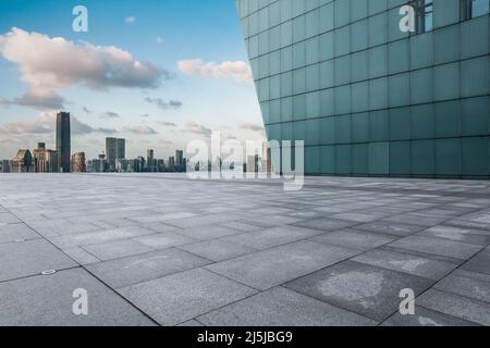 Leerer quadratischer Boden und Skyline der Stadt mit Gebäuden in Shanghai bei Sonnenuntergang, China. Stockfoto