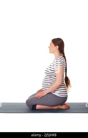 Schwanger Frau macht Yoga Asana Virasana Stockfoto