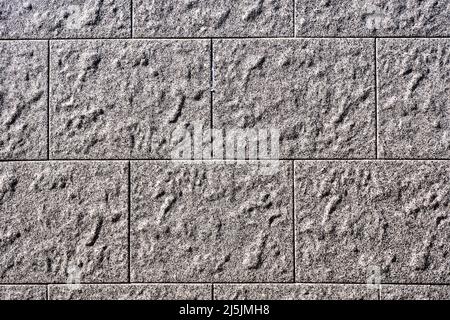 Hintergrund von einer Wand mit rechteckigen grauen Steinplatten Stockfoto