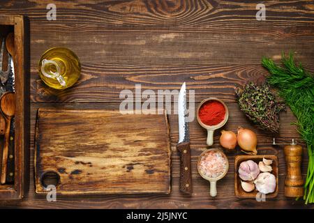 Kulinarisches Konzept. Blick von oben auf den Küchentisch mit Gewürzen, Kräutern und Utensilien. Stockfoto