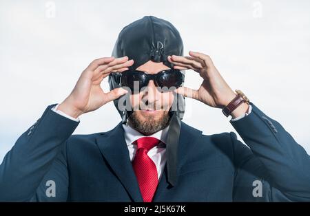 Positiver Geschäftsmann im Anzug und Pilotenhut machen Sie sich bereit Stockfoto