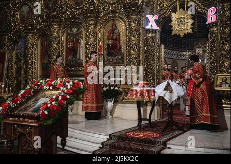 Bucha, Kiew, Ukraine. 24. April 2022. Priester gesehen mit Brot und Korb. Der orthodoxe Ostergottesdienst in der Nacht - vom späten Samstagabend bis zum frühen Sonntagmorgen - wurde in der Golden Domed Cathedral von St. Michael in Kiew im Beisein des Metropoliten Epifany, des Klerus und einiger weniger Menschen aufgrund der nationalen Ausgangssperre gefeiert. Die Zeremonie wurde für Online-Streaming für engagierte Menschen aufgezeichnet. (Bild: © Valeria Ferraro/ZUMA Press Wire) Stockfoto