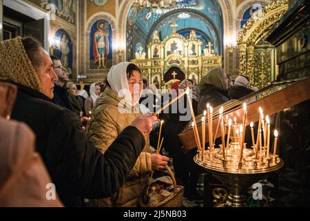 Frauen zünden Kerzen als Zeichen von Licht und Reinheit in der Kathedrale der orthodoxen Kirche in Moldawien an. Ostern in Chisinau wurde in diesem Jahr unter leichter Spannung gefeiert. Der bewaffnete Konflikt auf dem Territorium seines Nachbarlandes, der Ukraine, hat das aktuelle moldauische Panorama verändert. In der letzten Woche wurden die Alarme aufgrund angeblich verbreiter Informationen, die den Kampf auf dieses Land ausweiten könnten, wieder eingeschaltet. In diesem Szenario kamen in diesem Jahr Tausende von Menschen, um um Frieden zu bitten. Ostern wird traditionell jedes Jahr im Monat April gefeiert, die letzte Feier ist die Stockfoto