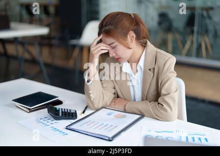 Burnout-Syndrom. Porträt der asiatischen Geschäftsfrau fühlt sich unbehaglich beim Arbeiten. Die durch Stress, durch erfolglose Arbeit angesammelt und weniger verursacht wird Stockfoto