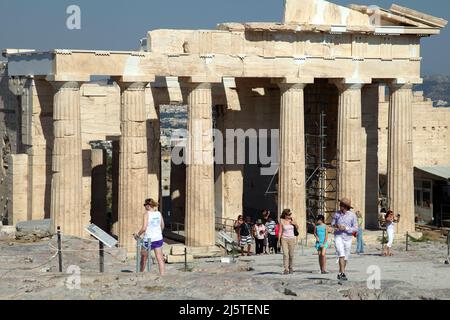 ATHEN, GRIECHENLAND - 26. JUNI: Touristen im berühmten Gateway Propylaea auf der Akropolis am 26. Juni 2011 in Athen, Griechenland. Propylaea ist der Haupteingang, durch den Tausende von Touristen passieren. Stockfoto