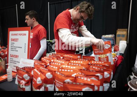 Edison, New Jersey, USA. 13. März 2022. Arbeiter für Popcorn für die Menschen stellen Popcorntüten während der Chocolate Expo im New Jersey Convention and Exposition Center in Raritan, NJ, zum Verkauf bereit die Chocolate expo ist nach einer zweijährigen Pause nach der Pandemie wieder im Zentrum. Popcorn für die Menschen ist ein Autismus-Basisarbeitgeber. Die Expo begann 2006 im Bundesstaat New York und ist die größte schokoladenmesse der USA. Auf der Expo werden Lebensmittelverkäufer aus ganz New Jersey, New York und Pennsylvania mit Schokolade, Käse, Rum und Cupcakes, Wein und anderen schokoladenbezogenen Lebensmitteln und M vorgestellt Stockfoto