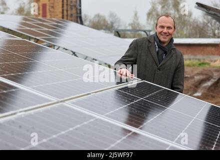 25. April 2022, Sachsen, Zwickau: Wolfram Günther (die Grünen), Sachsens Energie- und Klimaschutzminister, steht in einem neuen Solarpark. Die Enerparc AG betreibt den sechs Hektar großen Solarpark Mosel und wird in den nächsten 20 Jahren jährlich 5,5 Millionen kWh Solarenergie für die Produktion der vollelektrischen Volkswagen-Modelle aus Zwickau liefern. Alle drei Volkswagen-Standorte in Sachsen werden bereits seit Ende 2017 mit Ökostrom aus Wasserkraft versorgt. Bisher kam dies jedoch aus Österreich. Zwickau ist nun der erste sächsische Standort, der Solarenergie für die Fahrzeugproduktion erhält Stockfoto