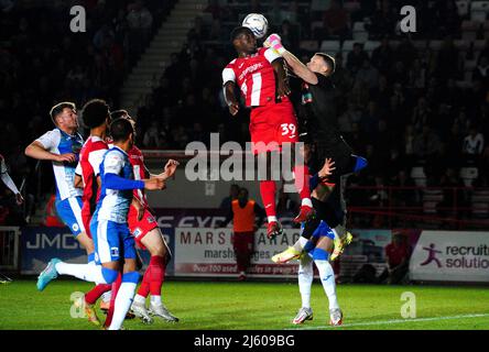 Cheick Diabate von Exeter City versucht, den Ball unter dem Druck von Barrow-Torwart Paul Farman während des Spiels der Sky Bet League Two im St James Park, Exeter, zu führen. Bilddatum: Dienstag, 26. April 2022. Stockfoto