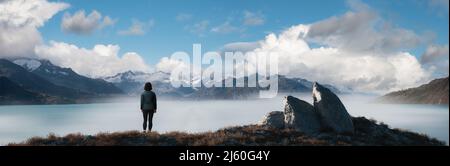 Frau, die an der Rocky Ocean Coast steht. Wolkenverhangener Himmel – Art Rendern. Stockfoto