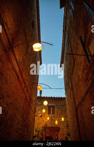 Italien, Provinz Siena, Radicondoli, Lanterns beleuchtete Altstadtallee Stockfoto