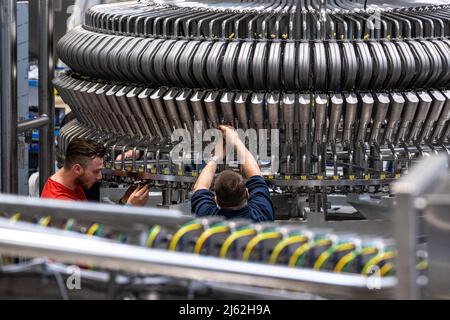 Neutraubling, Deutschland. 25. April 2022. Mitarbeiter der Krones AG an einer Abfüllanlage in der Produktion. Quelle: Armin Weigel/dpa/Alamy Live News Stockfoto