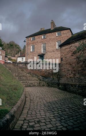 Altes Haus auf einer geschwungenen Treppe in der Ironbridge Gorge im Stadtteil Telford und Wrekin in Shropshire, England. Stockfoto