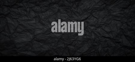 Schwarz zerknittertes Papier Textur Hintergrund Stockfoto