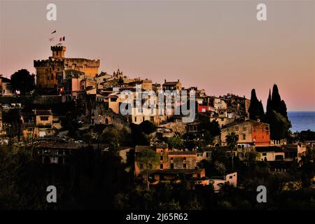 Altes mittelalterliches Dorf von Haut-de-Cagnes in Cagnes sur Mer, Frankreich, an der französischen Riviera. Dorf von einem benachbarten Hügel bei Sonnenuntergang im Winter gesehen. Stockfoto