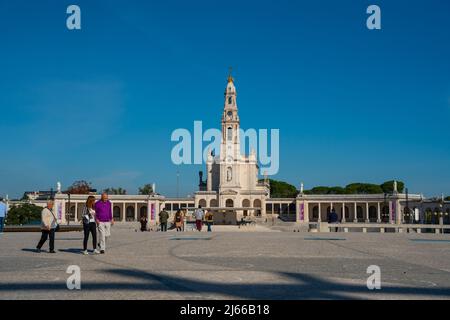 Fatima, Portugal - 13 2022. november - Menschen passieren den Platz vor der Basilika unserer Lieben Frau vom Rosenkranz von Fatima Stockfoto