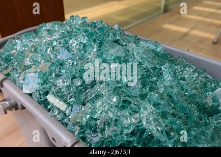 Eimer mit zerbrochenen Scherben aus gehärtetem Glas von einer beschädigten Glastür. Stockfoto