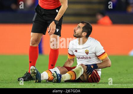 Leicester, Großbritannien. 28. April 2022. Henrikh Mkhitaryan #77 of Roma goes down with and injury Credit: News Images /Alamy Live News Stockfoto