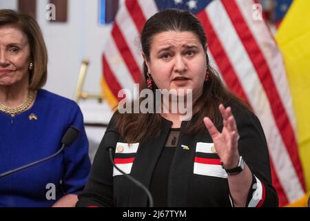 Die Botschafterin der Ukraine in den Vereinigten Staaten, Oksaná Markarova, rechts, hält eine Rede, während sie sich der Sprecherin des Repräsentantenhauses der Vereinigten Staaten, Nancy Pelosi (Demokratin von Kalifornien), zur Enthüllung der Fotoausstellung über die russische Invasion der Ukraine, im US-Kapitol in Washington, DC, am Donnerstag, 28. April 2022. In Zusammenarbeit mit der Botschaft der Ukraine werden in dieser Ausstellung sechs Wochen lang Bilder gezeigt, die den Schrecken der russischen Invasion und den Heldentum des ukrainischen Volkes festhalten, mit einer Sichtzeit von 9:00 Uhr â 6:00 Uhr. Cred Stockfoto