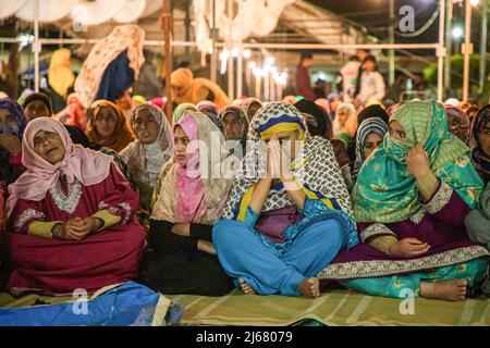 Muslimische Frauen aus Kaschmir versammeln sich in der Nacht von Shab-e-Qadr, 27.. Nacht des Heiligen Monats Ramadan, zu Gebeten in einer Moschee in Charar-e-Sharief Budgam. Shab-e-Qadr oder Lailat-ul-Qadr oder die Nacht der Macht ist die heiligste Nacht im islamischen Kalender. Muslime glauben, dass in dieser Nacht die ersten Verse des islamischen Heiligen Buches Koran dem Propheten Mohammed enthüllt wurden. Im Koran heißt es: "Die Nacht von Al-Qadr ist besser als tausend Monate. In der Zwischenzeit beschließen die indischen Behörden in Kaschmir, Shab-e-Qadr und Jumat-ul-Vida (am vergangenen Freitag Gebete des Ramadan) im historischen Jamia Masjid in Srina nicht zuzulassen Stockfoto