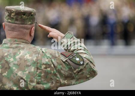 Bukarest, Rumänien - 28. April 2022: Rumänischer Landstreitungssoldat begrüßt während einer öffentlichen Zeremonie. Stockfoto