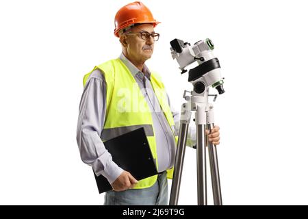 Geodätische Ingenieurin, die mit einer auf weißem Hintergrund isolierten Positionierstation misst Stockfoto