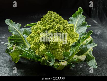 Romanesco Brokkoli Kopf auf einer dunklen Steinoberfläche, Kohl, Nahaufnahme, fibonacci-Sequenz, für diejenigen, die Mathematik lieben, Stock Foto Stockfoto