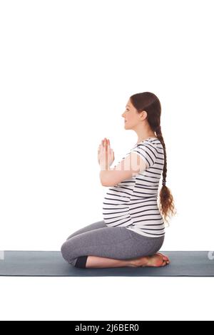 Schwanger Frau macht Yoga Asana Virasana Stockfoto