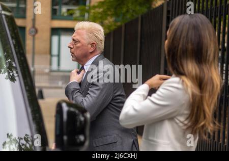 Bild zeigt: Boris Becker straightens seine Wimbledon Krawatte im Fenster Spiegelung eines Taxis, als er in seiner Wimbledon Krawatte in der Spiegelung von Th ankommt Stockfoto