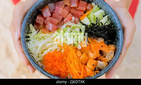 Gesundes Essen mit rohen Meeresfrüchten und Gemüse. Poke eine Schüssel mit Lachs und Thunfisch Stockfoto