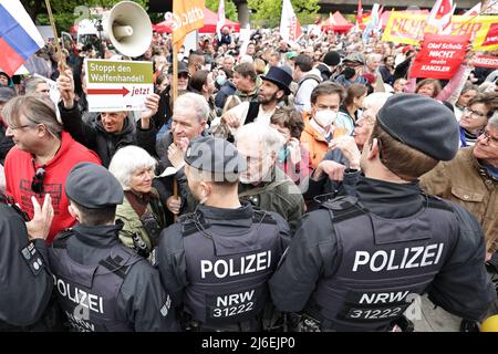 01. Mai 2022, Nordrhein-Westfalen, Düsseldorf: Menschen nehmen an der 1. Mai-Kundgebung des Deutschen Gewerkschaftsbundes (DGB) zum Tag der Arbeit Teil und stehen Polizisten gegenüber. Foto: David Young/dpa Stockfoto