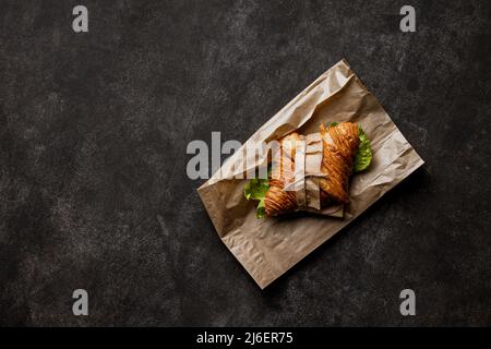 Frisch gebackenes Croissant auf Steingrund. Ansicht von oben Stockfoto